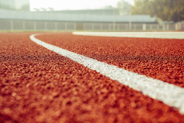 detail of a running track in a stadium - running track imagens e fotografias de stock
