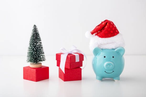 istock Piggy bank with christmas hat, gift box, christmas tree 1187115084