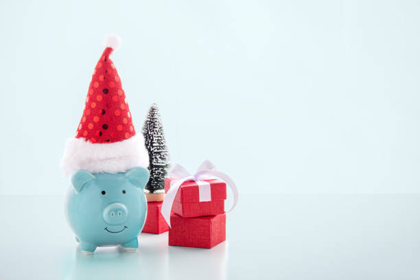 istock Piggy bank with christmas hat on blue background 1187115266