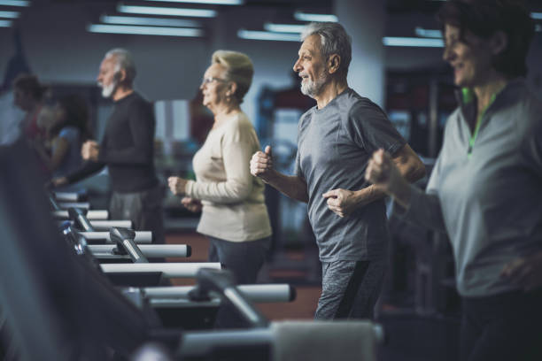 istock Active senior people jogging on treadmills in a gym. 1187117681