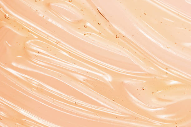 Orange cosmetic gel background Serum, liquid gel texture. Clear cosmetic cream background. Transparent orange colored skin care product sample. Vitamin C treatment amino acid photos stock pictures, royalty-free photos & images