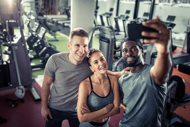 istock Happy athletic friends taking a selfie on a break in a gym. 1187121681