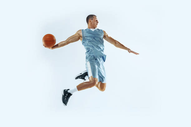 istock Young caucasian basketball player against white studio background 1187122407
