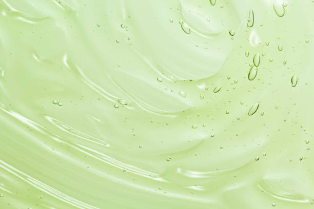 sfondo texture gel cosmetico aloe vera verde - gel per capelli foto e immagini stock