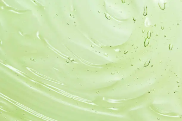 Photo of Green aloe vera cosmetic gel texture background