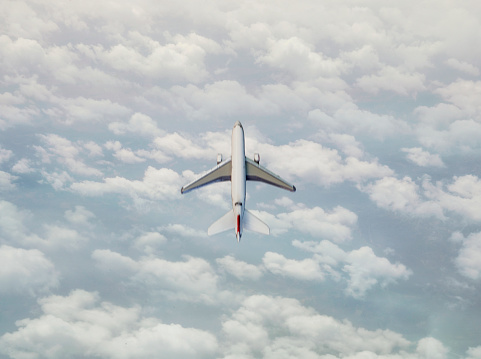 Airplane flying above clouds