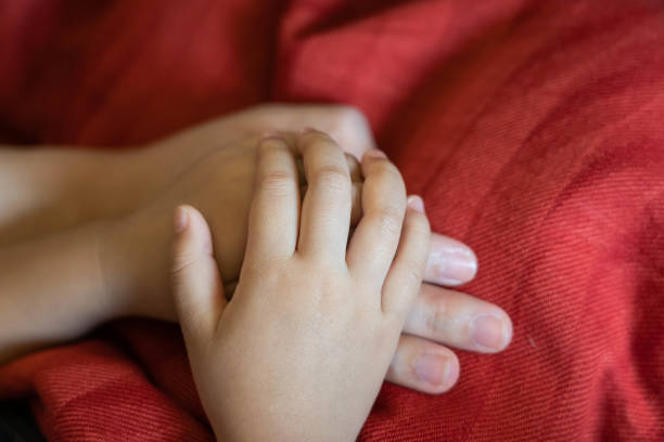 istock Daughter and mother holding hands 1187128305
