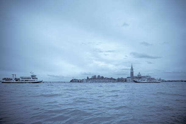 Venice canal view at night with San Giorgio Maggiore and historical buildings. Italy.