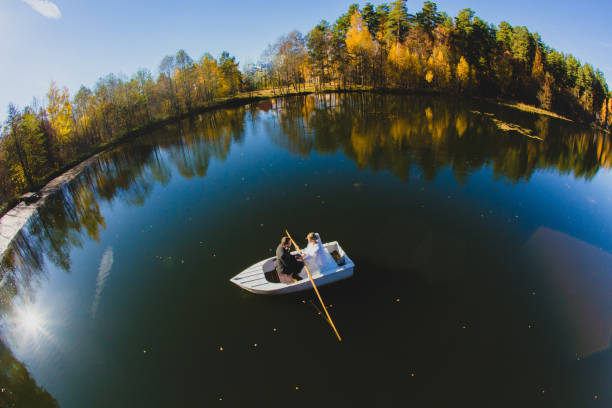 istock Beautiful young wedding couple on small boat sailing on a pond 1187131244