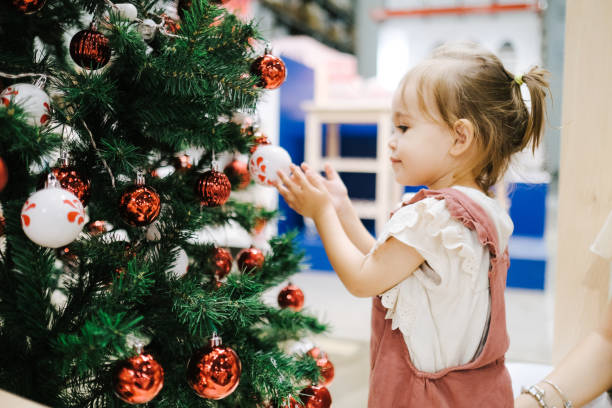 istock Decorating Christmas Tree with Ornaments and Christmas Lights 1187132116