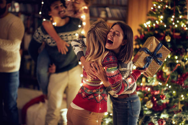 istock Happy surprise for friend with present at Christmas. 1187136793