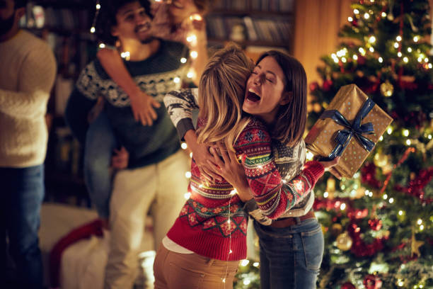 Happy surprise for friend with present at Christmas. Happy surprise for friend with present at Christmas and and New Year. family christmas stock pictures, royalty-free photos & images