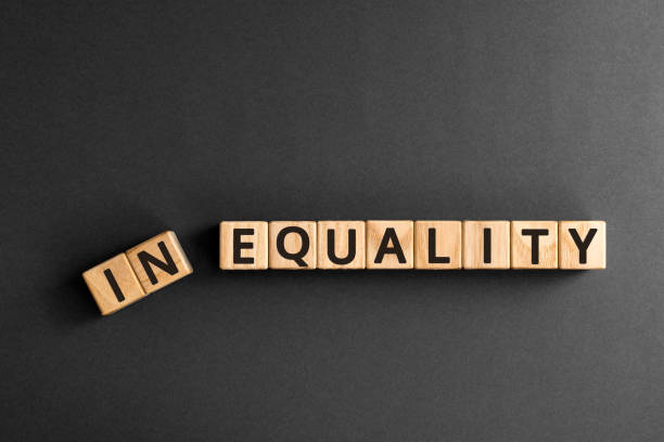 Inequality to equality - word from wooden blocks with letters Inequality to equality - word from wooden blocks with letters, economic social inequality concept,  top view on grey background unfairness photos stock pictures, royalty-free photos & images