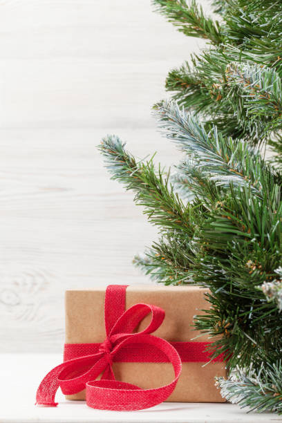 istock Christmas card with fir tree and gift 1187138934