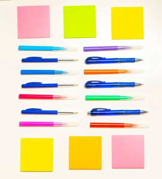 Colorful felt-tip pens on the white background. Markers and stickers pattern. Background or texture.