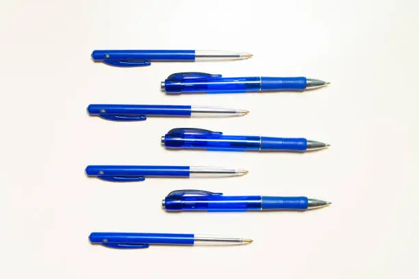 Blue pens on the white background. Fountain pens pattern. Background or texture.