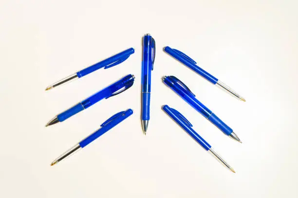 Blue pens on the white background. Fountain pens pattern. Background or texture.