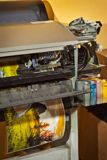 old broken printer in workshop. the concept of cleaning and calibrating printers. sunset and red sky with clouds in the photo. picturesque nature photo printed on printing equipment. - photobusiness imagens e fotografias de stock