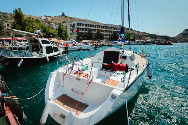 Yacht on the city promenade on a summer sunny day