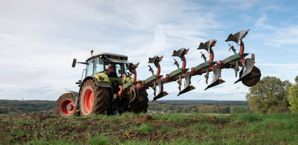 istock tractor and plow under blue sky on field in luxembourgh 1187146568