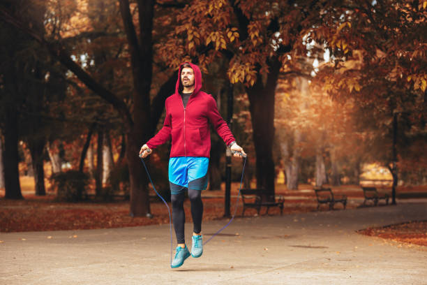 istock Man jumping rope outdoors on sunny autumn morning. 1187146652