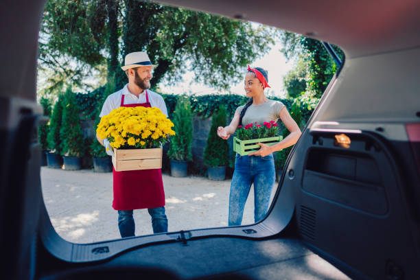 istock Florist placing flowers in client's car 1187148260
