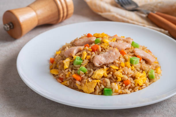 istock Fried rice chicken with egg and vegetables on white plate 1187148350