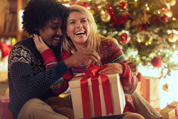 istock Cheerful boy and girl exchanging Christmas presents 1187148428