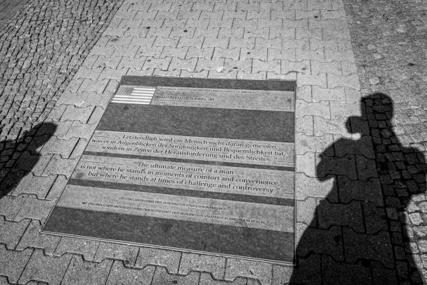 Berlin, Germany - September 2, 2015: A public sidewalk in Berlin contains a quote in Germany and English by Martin Luther King: \