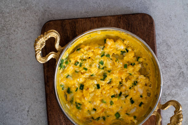 istock Scrambled eggs with cheese and spring onion. Served in a copper pan. 1187149229