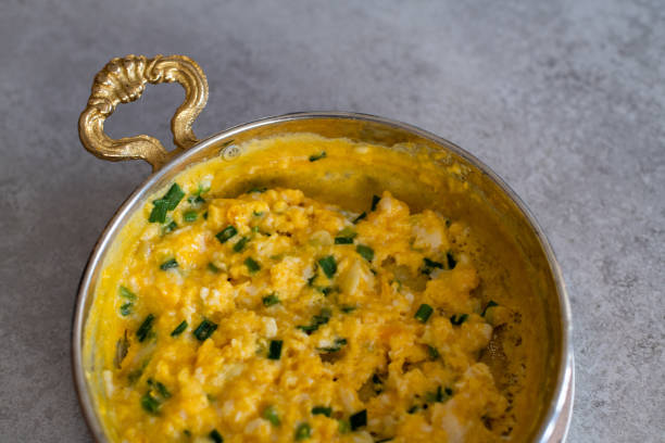 istock Scrambled eggs with cheese and spring onion. Served in a copper pan. 1187149551