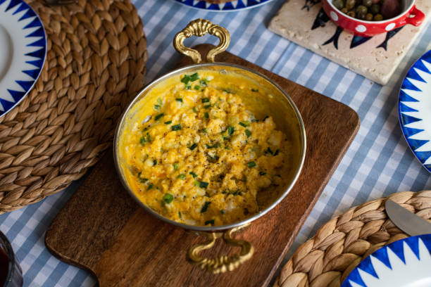 istock Scrambled eggs with cheese and spring onion. Served in a copper pan. 1187150947