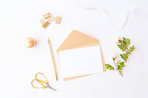 istock Mockup wedding invitation and envelope with small white flowers and green leaves on a white background 1187151771