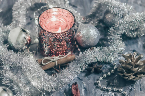 istock Shiny candlestick with a burning candle on a silver background with festive decorations. Flat lay card 1187152728