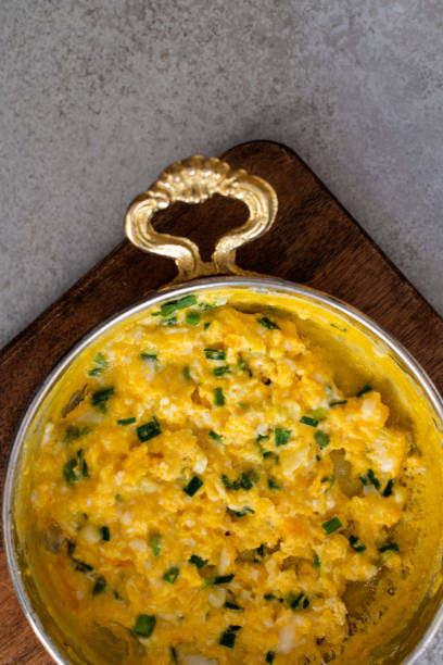 istock Scrambled eggs with cheese and spring onion. Served in a copper pan. 1187152879