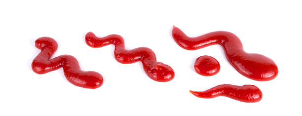 istock Red tomato ketchup splashes isolated on white background, 1187153775