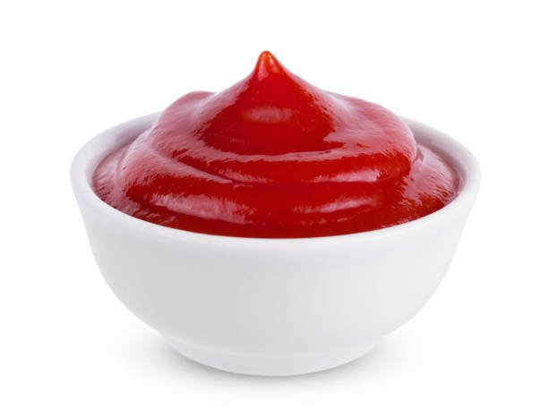 Red tasty ketchup or tomato sauce in bowl isolated on white background ketchup or tomato sauce in bowl isolated on white background ketchup stock pictures, royalty-free photos & images