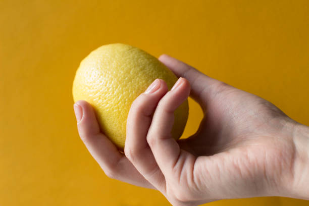 istock young woman holding a lemon 1187153941