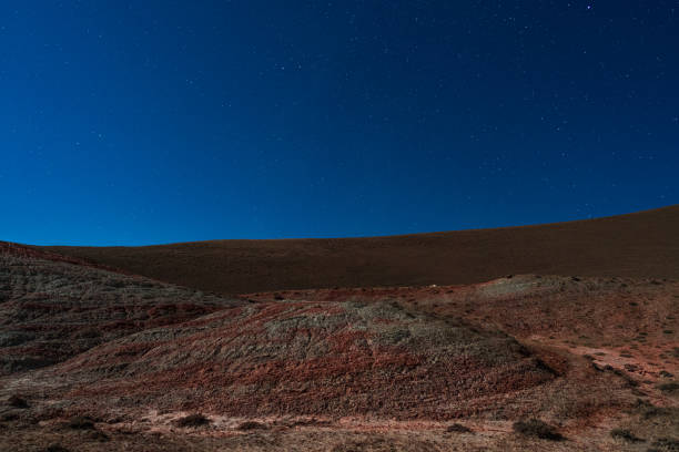 Amazing striped red mountains on a moon night