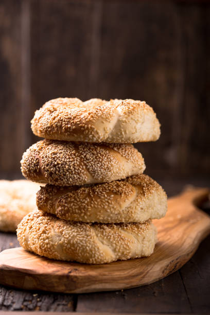 Greek koulouri or Turkish bagels called Simit in stack. Traditional street food, crispy sesame bread ring bagels Greek koulouri or Turkish bagels called Simit in stack. Traditional street food, crispy sesame bread ring bagels turkish bagel simit stock pictures, royalty-free photos & images