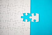 istock Puzzle Concept - White Jigsaw Puzzle Pieces On Blue Background 1187165509
