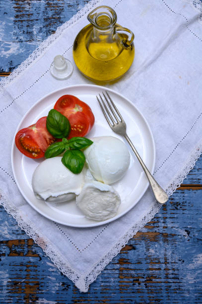 istock Cheese collection, organic mozzarella soft cheese served with ripe tomato and fresh green basil 1187167869