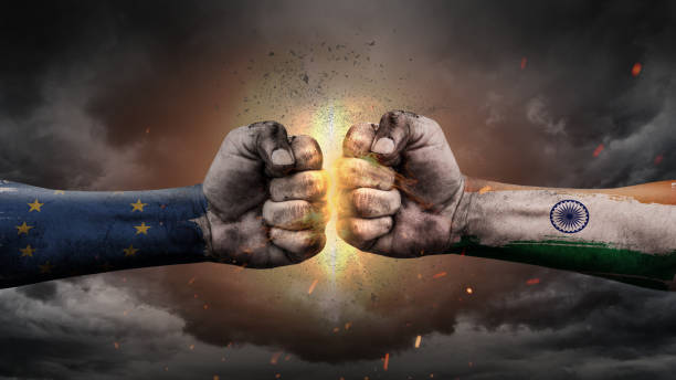 istock EU vs India. Fists with flags. Battle EU with India on sky. 1187168252
