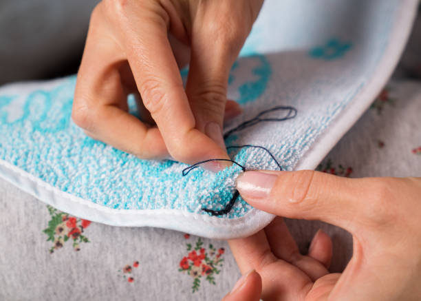 istock Dressmaker sews up clothes 1187168273