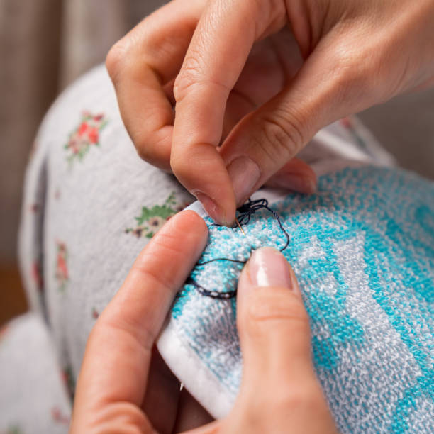 istock Craftsman sews and mending clothes 1187168283