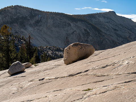 Rocks sitting on a smooth mountain side in Yosemite National Park