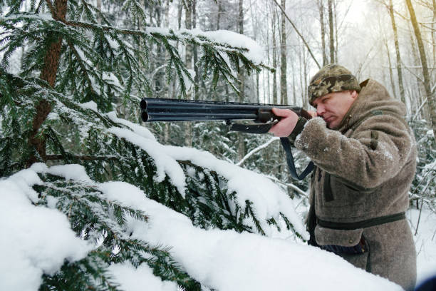 istock A hunter with a gun. Winter hunting. Huntsman. 1187172301