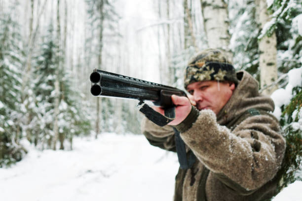istock A hunter with a gun. Winter hunting. Huntsman. 1187172427