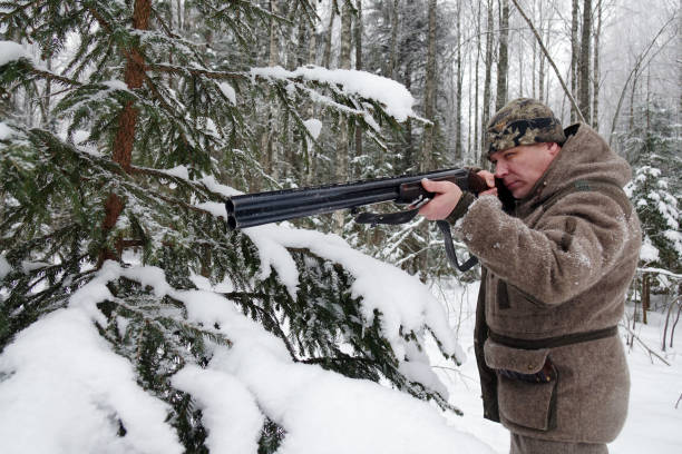 istock A hunter with a gun. Winter hunting. Huntsman. 1187172435