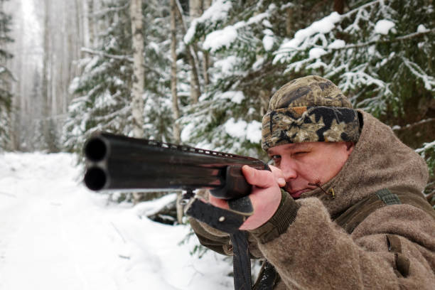 istock A hunter with a gun. Winter hunting. Huntsman. 1187172482